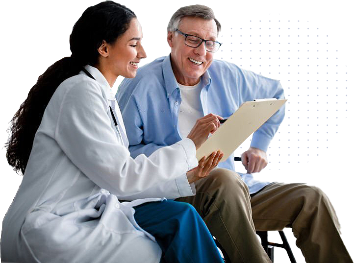 Female doctor smiling and discussing medical information on a clipboard with an older male patient in a wheelchair